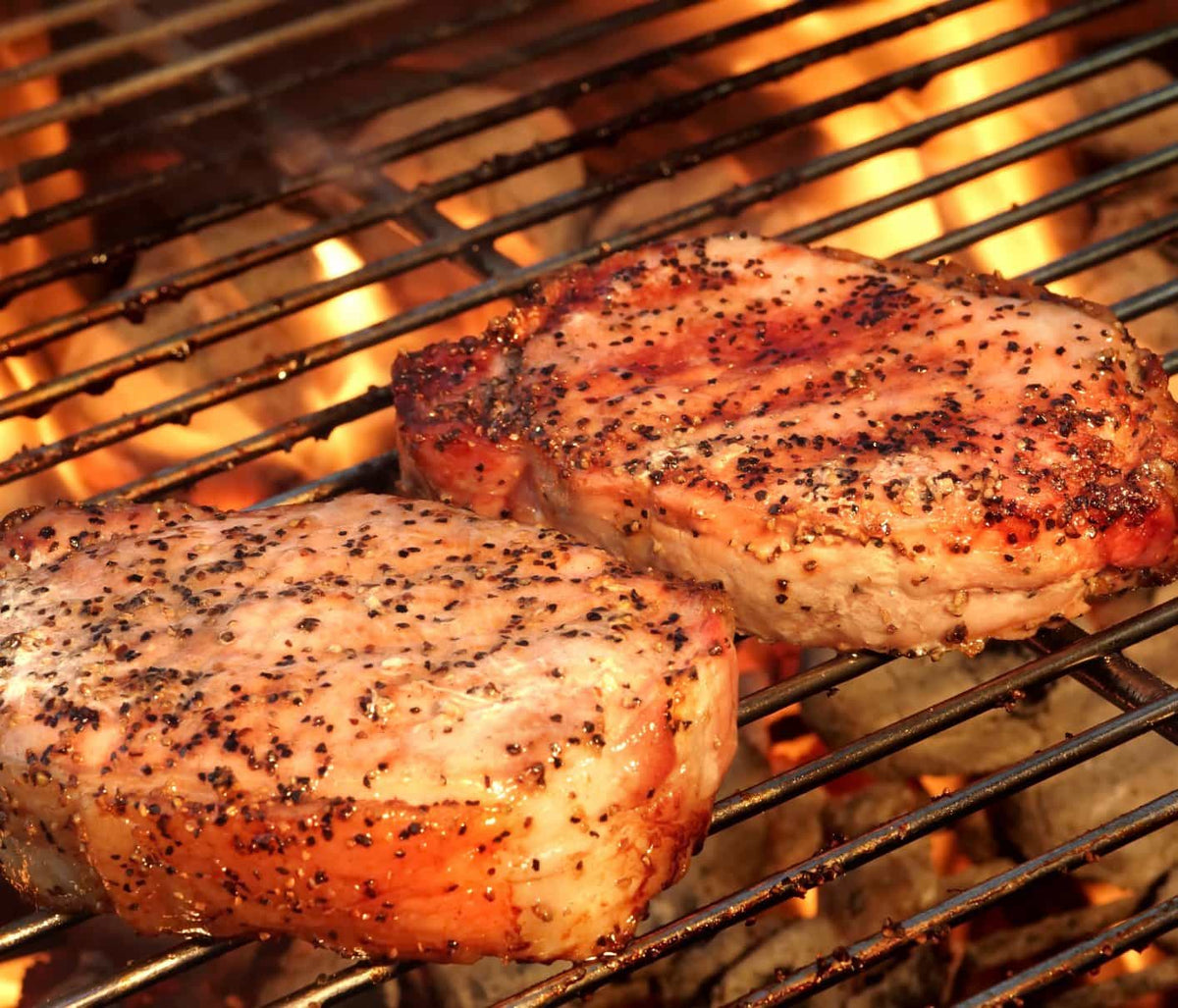 2 Pork Pieces on a grill with pepper crust and ready to serve