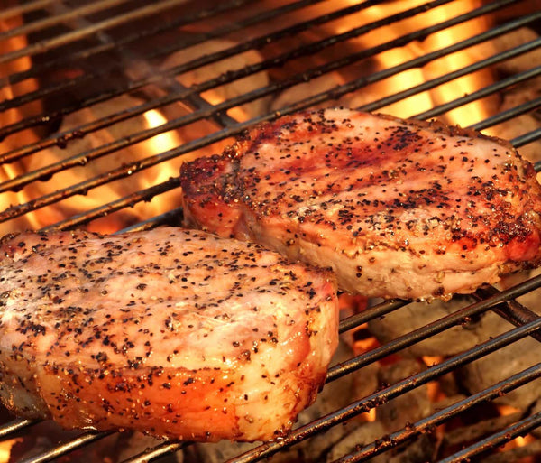 2 Pork Pieces on a grill with pepper crust and ready to serve